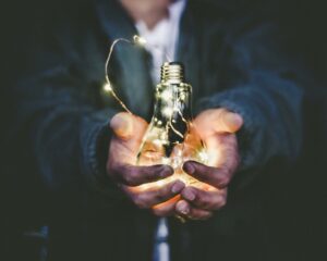 Hands holding a light bulb. Photo by Riccardo Annandale on Unsplash