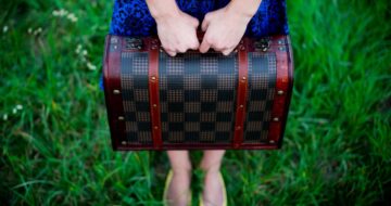 girl holding retro vintage suitcase
